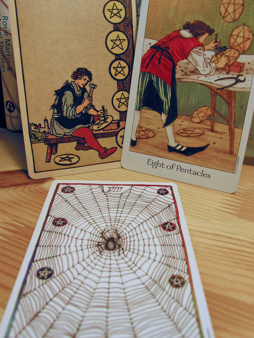 Eight of Pentacles. Smith-Waite Centennial Deck, Dreaming Way Tarot, Wild Unknown Tarot